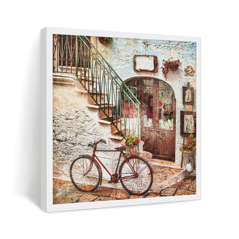 vintage scenery of a street with a bicycle standing in alley way in white frame 