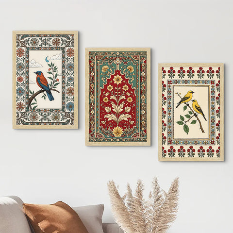 Three framed artworks with floral and bird designs on a wall above a sofa.