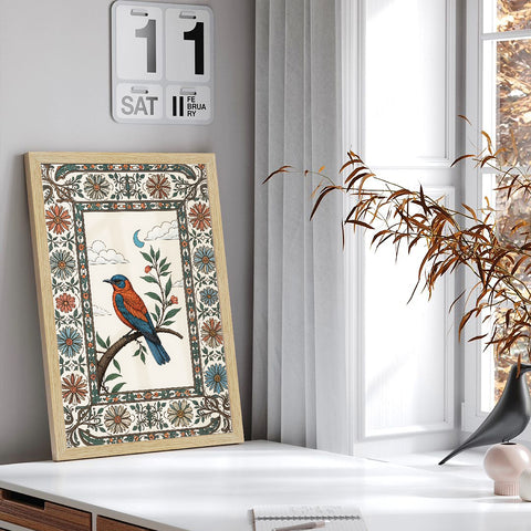 Decorative framed artwork with a bird design on a shelf next to a window.
